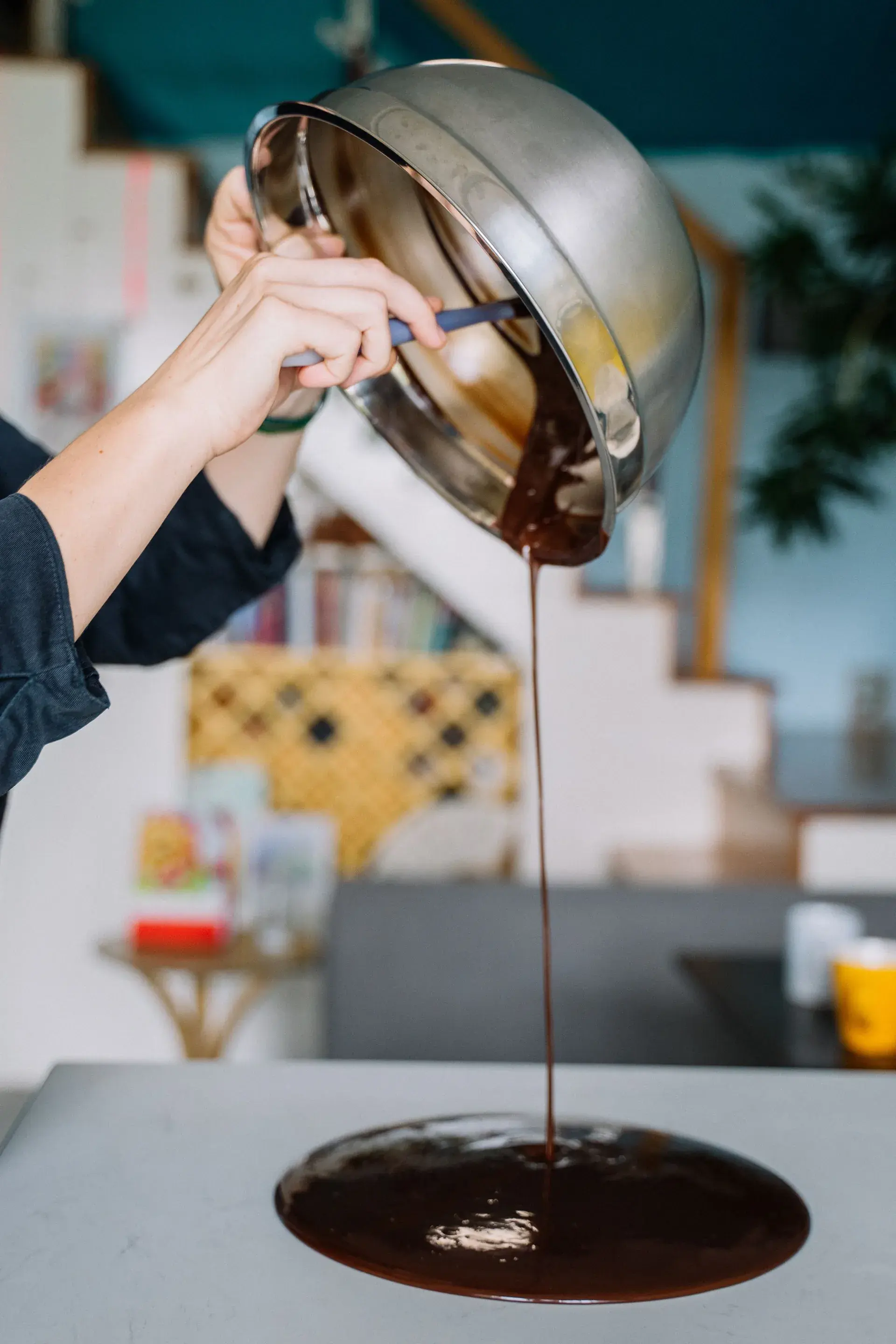 A chocolate melter mid-pour