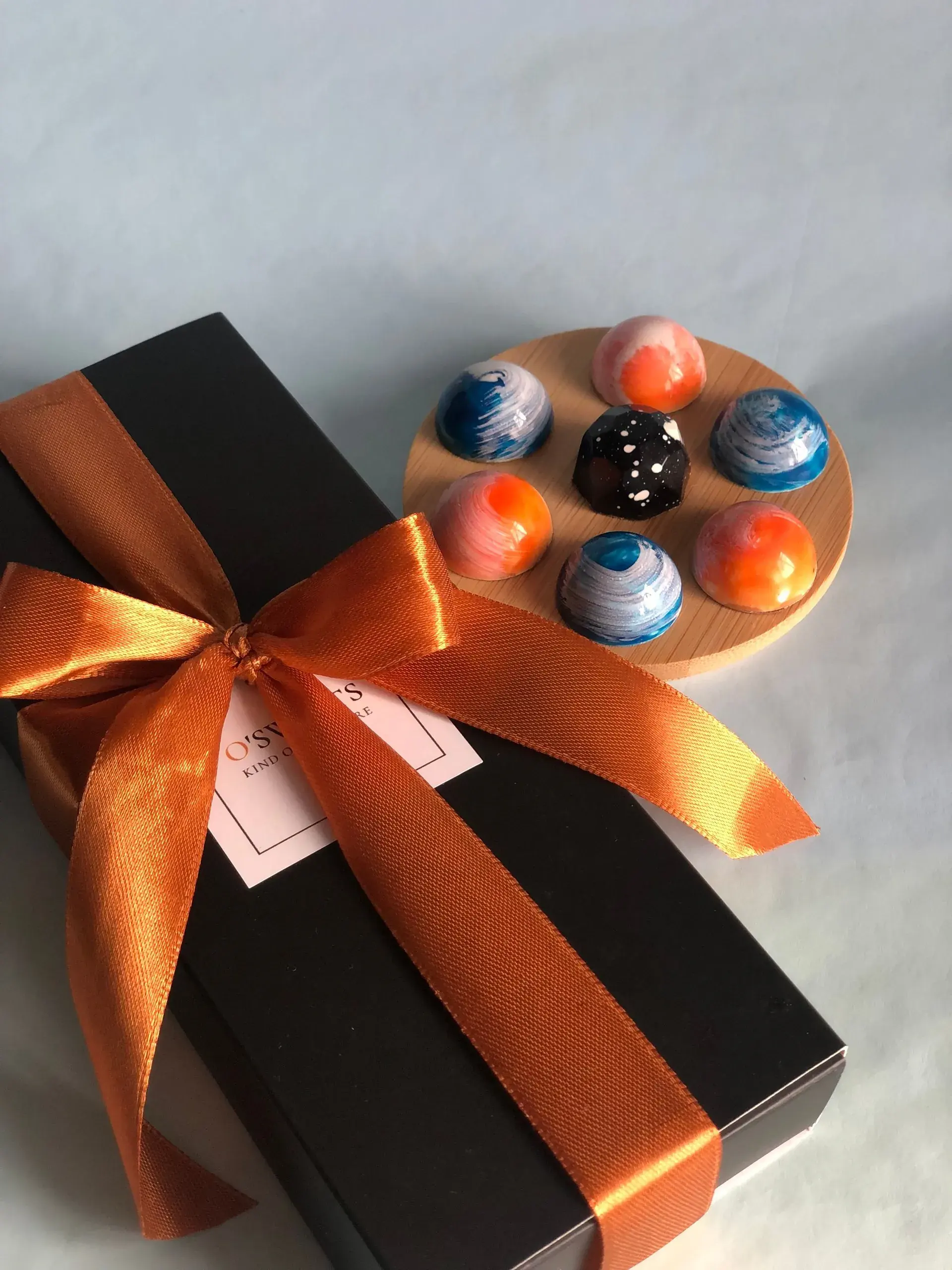 A dark gift box tied with a ribbon